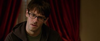 Movie still from “National Treasure” (2004), directed by Jon Turteltaub – A person wearing glasses; Close Up shot, Over the shoulder angle