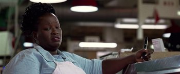 Movie still from “National Treasure” (2004), directed by Jon Turteltaub – A woman sitting in a chair in a room with lights; Close Up shot, Low angle