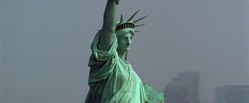Movie still from “National Treasure” (2004), directed by Jon Turteltaub – The statue of liberty is seen in the background; Wide shot, Low angle