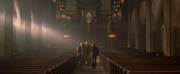 Movie still from “National Treasure” (2004), directed by Jon Turteltaub – A group of people standing in front of an organ in a church; Wide shot, Low angle