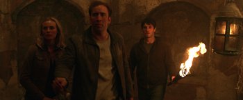Movie still from “National Treasure” (2004), directed by Jon Turteltaub – A couple of men are walking in the dark; Medium shot, Over the shoulder angle