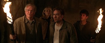 Movie still from “National Treasure” (2004), directed by Jon Turteltaub – A group of people standing next to each other in a room; Medium shot, Low angle