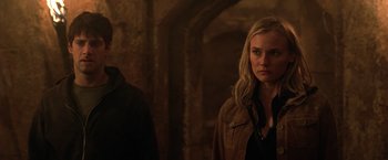 Movie still from “National Treasure” (2004), directed by Jon Turteltaub – A woman standing next to a man in a dark room; Close Up shot, Over the shoulder angle