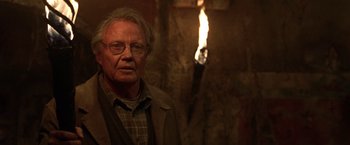 Movie still from “National Treasure” (2004), directed by Jon Turteltaub – An older man with glasses and a beard; Close Up shot, Over the shoulder angle