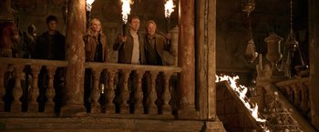 Movie still from “National Treasure” (2004), directed by Jon Turteltaub – A group of people standing next to each other holding torches; Wide shot, Low angle