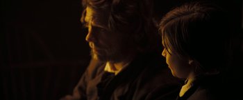 Movie still from “National Treasure: Book of Secrets” (2007), directed by Jon Turteltaub – A man and a woman sitting next to each other in a dark room; Close Up shot, Over the shoulder angle