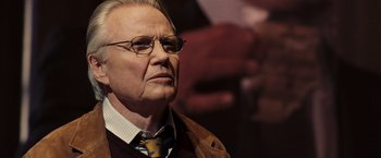 Movie still from “National Treasure: Book of Secrets” (2007), directed by Jon Turteltaub – An older man wearing glasses and a neck tie; Close Up shot, Over the shoulder angle