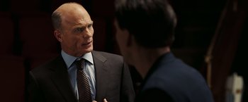 Movie still from “National Treasure: Book of Secrets” (2007), directed by Jon Turteltaub – A man in a business suit talking to another man in a business suit; Close Up shot, Over the shoulder angle