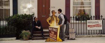 Movie still from “National Treasure: Book of Secrets” (2007), directed by Jon Turteltaub – Two men standing on the steps of a building; Wide shot, Over the shoulder angle