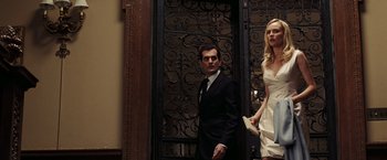 Movie still from “National Treasure: Book of Secrets” (2007), directed by Jon Turteltaub – A man and a woman standing in front of a door; Medium shot, Low angle