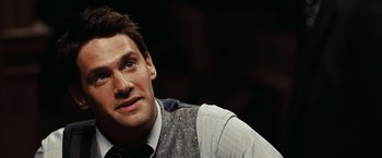 Movie still from “National Treasure: Book of Secrets” (2007), directed by Jon Turteltaub – A person wearing a vest; Close Up shot, Over the shoulder angle