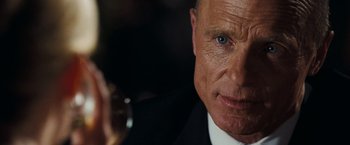 Movie still from “National Treasure: Book of Secrets” (2007), directed by Jon Turteltaub – A man in a suit and tie holding a glass of wine; Close Up shot, Over the shoulder angle