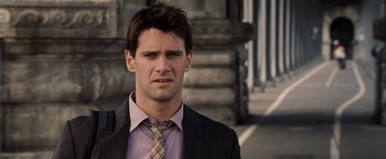 Movie still from “National Treasure: Book of Secrets” (2007), directed by Jon Turteltaub – A person wearing a suit and tie; Close Up shot, Over the shoulder angle