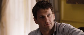 Movie still from “National Treasure: Book of Secrets” (2007), directed by Jon Turteltaub – A person wearing a gray shirt; Close Up shot, Over the shoulder angle