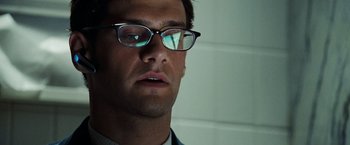 Movie still from “National Treasure: Book of Secrets” (2007), directed by Jon Turteltaub – A person wearing glasses and a suit; Close Up shot, Low angle