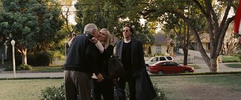 Movie still from “National Treasure: Book of Secrets” (2007), directed by Jon Turteltaub – A group of people standing next to each other on the grass; Medium shot, Over the shoulder angle