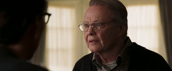 Movie still from “National Treasure: Book of Secrets” (2007), directed by Jon Turteltaub – An older man with glasses looking at the camera; Close Up shot, Over the shoulder angle