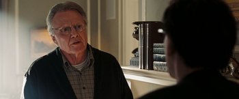 Movie still from “National Treasure: Book of Secrets” (2007), directed by Jon Turteltaub – An older man sitting in front of a bookshelf; Close Up shot, Over the shoulder angle