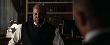 Movie still from “National Treasure: Book of Secrets” (2007), directed by Jon Turteltaub – An older man wearing a vest and a tie; Close Up shot, Over the shoulder angle