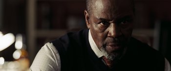 Movie still from “National Treasure: Book of Secrets” (2007), directed by Jon Turteltaub – An older man wearing a vest and a tie; Close Up shot, Low angle