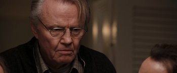 Movie still from “National Treasure: Book of Secrets” (2007), directed by Jon Turteltaub – An older man wearing glasses and a sweater; Close Up shot, Over the shoulder angle