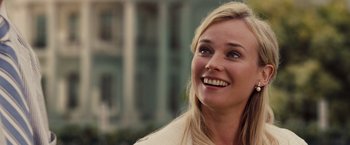 Movie still from “National Treasure: Book of Secrets” (2007), directed by Jon Turteltaub – A beautiful blonde haired woman smiling for the camera; Close Up shot, Over the shoulder angle