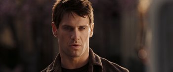 Movie still from “National Treasure: Book of Secrets” (2007), directed by Jon Turteltaub – A person wearing a brown shirt; Close Up shot, Over the shoulder angle