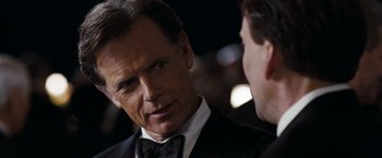 Movie still from “National Treasure: Book of Secrets” (2007), directed by Jon Turteltaub – A man in a tuxedo talking to another man in a suit; Close Up shot, Over the shoulder angle
