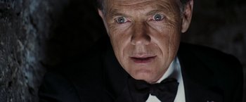 Movie still from “National Treasure: Book of Secrets” (2007), directed by Jon Turteltaub – An older man wearing a tuxedo and a bow tie; Close Up shot, Low angle