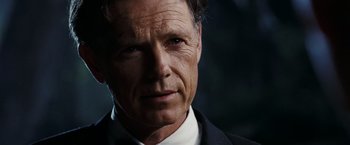 Movie still from “National Treasure: Book of Secrets” (2007), directed by Jon Turteltaub – A person wearing a suit and tie; Close Up shot, Low angle