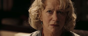Movie still from “National Treasure: Book of Secrets” (2007), directed by Jon Turteltaub – An older woman with blonde curly hair and blue eyes; Close Up shot, Low angle