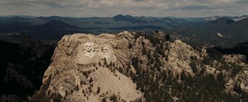 Movie still from “National Treasure: Book of Secrets” (2007), directed by Jon Turteltaub – A view of mount rushmore from a helicopter; Extreme Wide shot, High angle