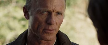 Movie still from “National Treasure: Book of Secrets” (2007), directed by Jon Turteltaub – An older man with a goatee looking at the camera; Close Up shot, Over the shoulder angle