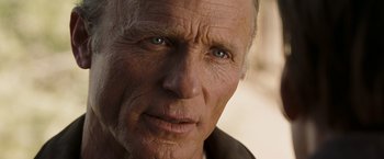 Movie still from “National Treasure: Book of Secrets” (2007), directed by Jon Turteltaub – An old man with a gray beard looking at the camera; Close Up shot, Over the shoulder angle