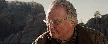 Movie still from “National Treasure: Book of Secrets” (2007), directed by Jon Turteltaub – An older man wearing glasses looking off into the distance; Close Up shot, Over the shoulder angle