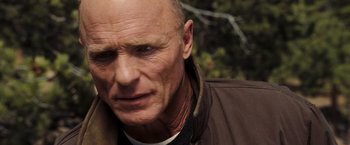 Movie still from “National Treasure: Book of Secrets” (2007), directed by Jon Turteltaub – A man with a bald head is looking at the camera; Close Up shot, Low angle