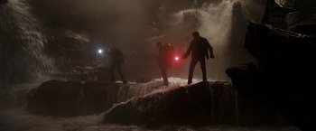 Movie still from “National Treasure: Book of Secrets” (2007), directed by Jon Turteltaub – Three people standing on a rock in the water at night; Wide shot, Low angle