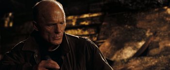 Movie still from “National Treasure: Book of Secrets” (2007), directed by Jon Turteltaub – An older man in a brown jacket looking at the camera; Close Up shot, Low angle