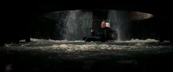 Movie still from “National Treasure: Book of Secrets” (2007), directed by Jon Turteltaub – A man sitting in a chair in front of a waterfall; Wide shot, High angle