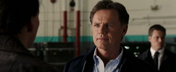 Movie still from “National Treasure: Book of Secrets” (2007), directed by Jon Turteltaub – A person wearing a shirt and jacket; Close Up shot, Low angle