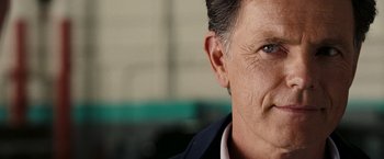 Movie still from “National Treasure: Book of Secrets” (2007), directed by Jon Turteltaub – A man's face with a smile on his face; Close Up shot, Over the shoulder angle