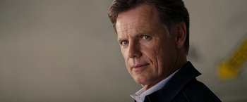 Movie still from “National Treasure: Book of Secrets” (2007), directed by Jon Turteltaub – A person wearing a suit and tie; Close Up shot, Low angle