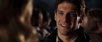 Movie still from “National Treasure: Book of Secrets” (2007), directed by Jon Turteltaub – A man smiling for the camera; Close Up shot, Over the shoulder angle