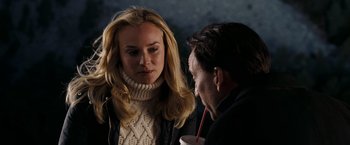 Movie still from “National Treasure: Book of Secrets” (2007), directed by Jon Turteltaub – A man and a woman standing next to each other holding a drink; Close Up shot, Over the shoulder angle