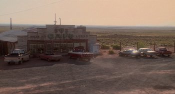 Movie still from “Natural Born Killers” (1994), directed by Oliver Stone – An old fashioned diner sits in the middle of a desert; Extreme Wide shot, High angle