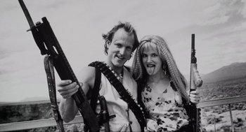 Movie still from “Natural Born Killers” (1994), directed by Oliver Stone – A man and a woman posing for a picture; Close Up shot, Low angle