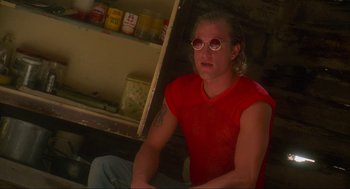 Movie still from “Natural Born Killers” (1994), directed by Oliver Stone – A man sitting in front of an open refrigerator; Medium shot, Low angle