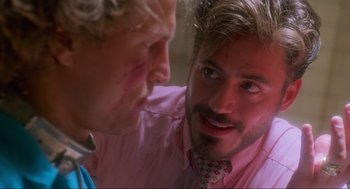 Movie still from “Natural Born Killers” (1994), directed by Oliver Stone – Two men in pink shirts and a pink tie; Close Up shot, Over the shoulder angle