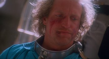 Movie still from “Natural Born Killers” (1994), directed by Oliver Stone – A person with a knife on his face; Close Up shot, Low angle