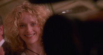 Movie still from “Natural Born Killers” (1994), directed by Oliver Stone – A person with curly blonde hair; Close Up shot, Over the shoulder angle